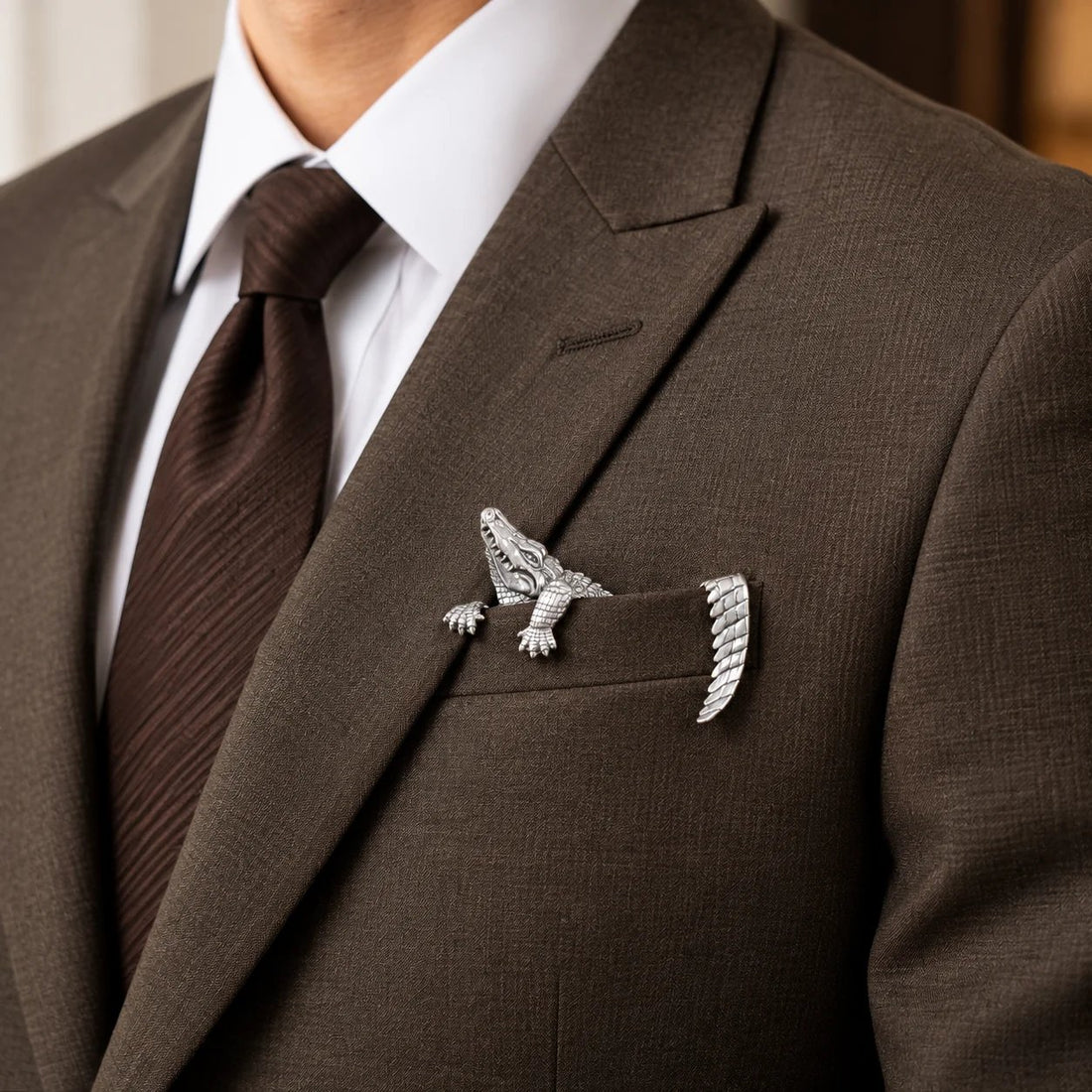 Silver alligator accessory worn with tailored suit