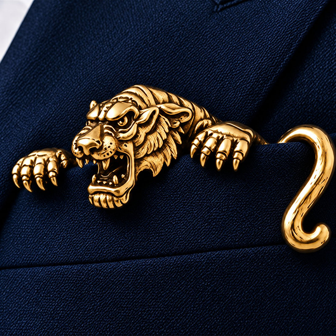 Gold sculptural tiger detail on navy jacket